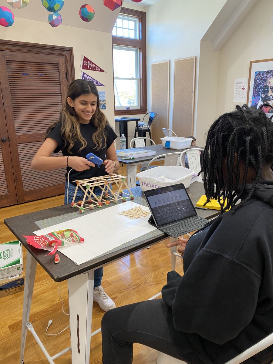 Woodward Middle School Students work together to construct the strongest possible popsicle stick bridge