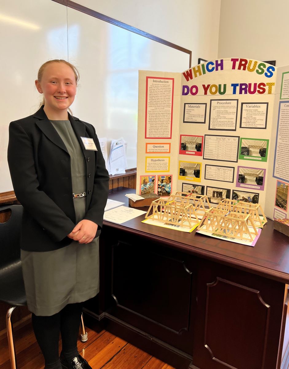 photo of student in front of science fair display