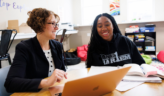 Woodward Student pictured with Woodward Admin working on a laptop together