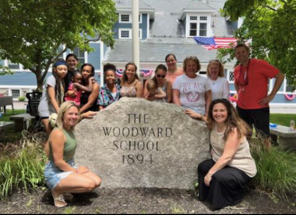 Woodward Alumnae poses at rock with head of school
