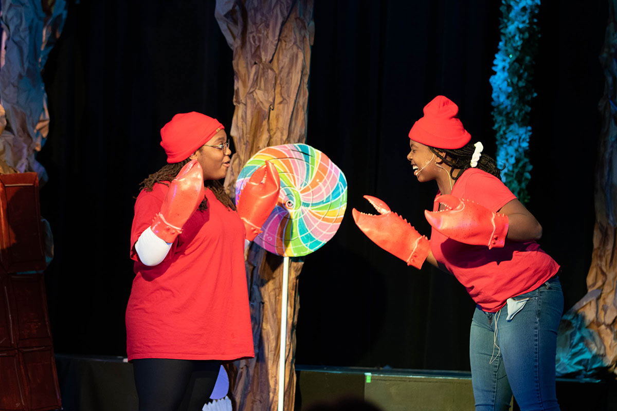 2 Woodward Students perform in crab costumes