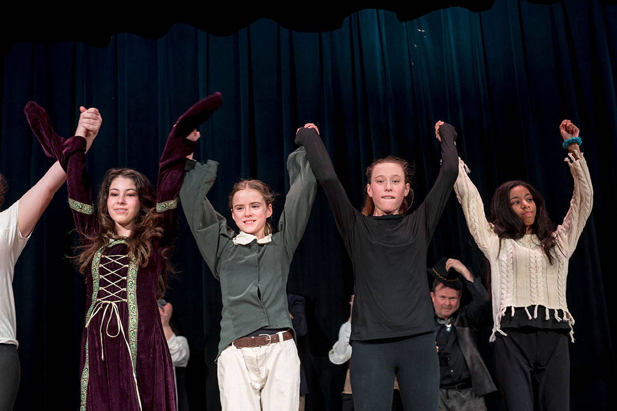 students take a bow on stage