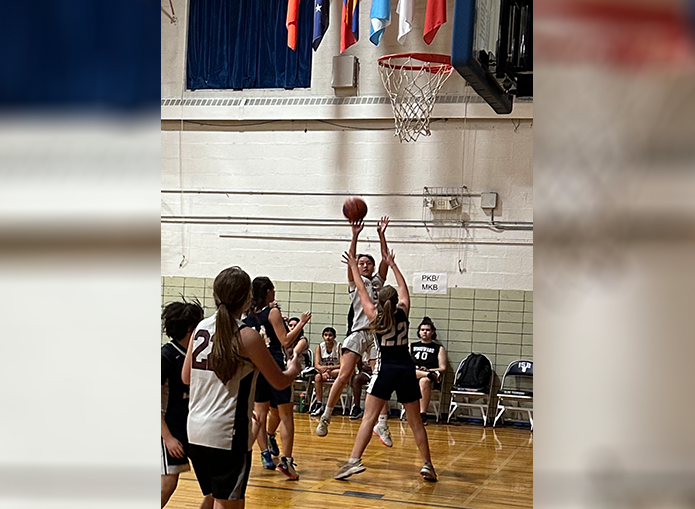 Woodward basketball player jumps to make the basket