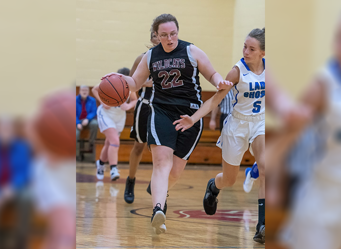 Woodward basketball player dribbles ball toward goal