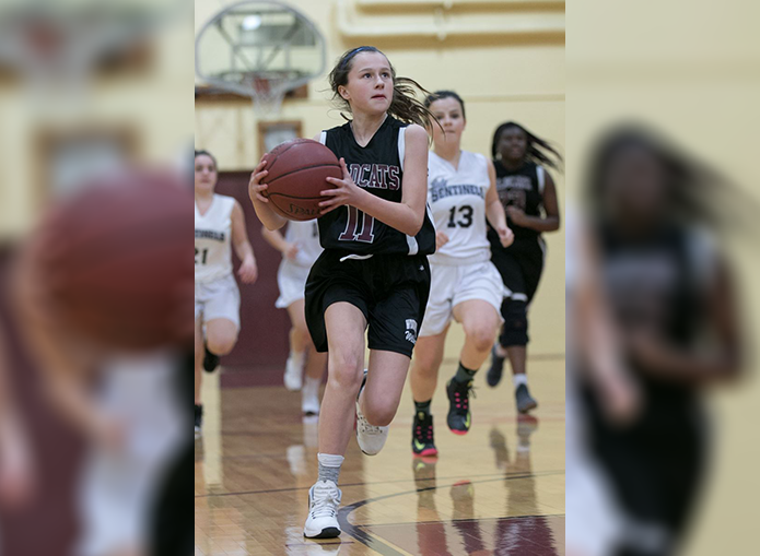 Woodward basketball player about to shoot a goal