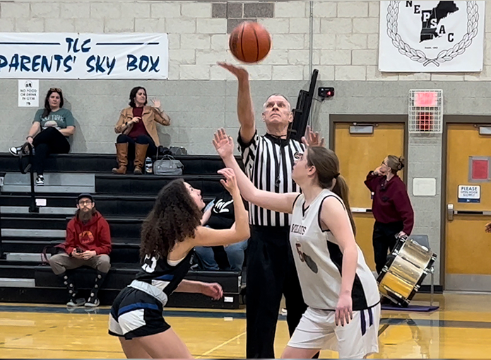 Woodward Basketball game tip off with two players and referee throwing up ball