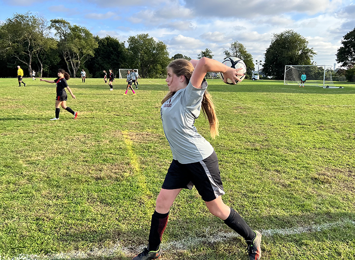 Woodward Soccer player throwing ball in