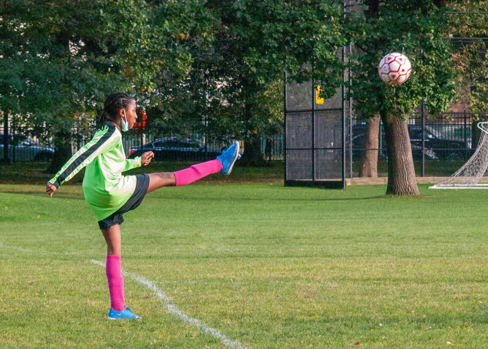 soccer player kicking ball in to game from out of bounds