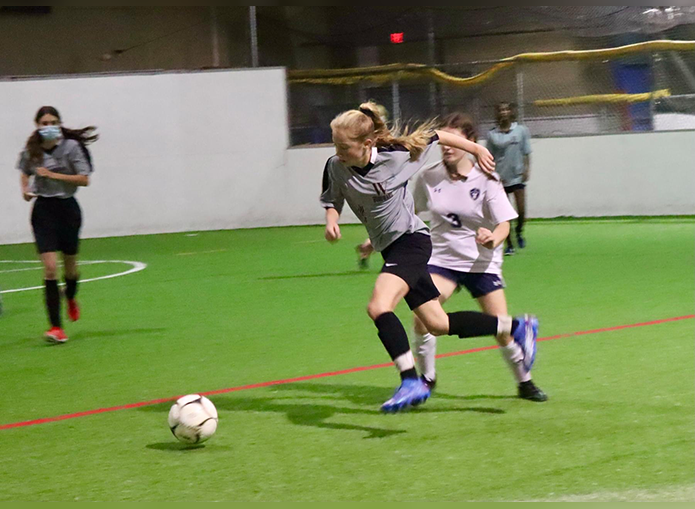 Woodward soccer player striving toward the goal