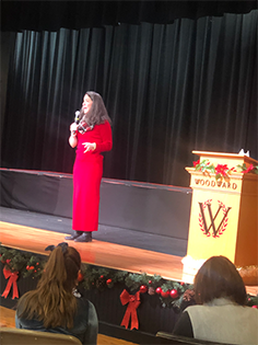 Female speaker on stage addressing audience