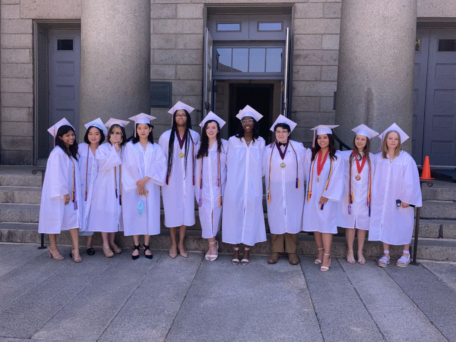 Photo of students at graduation in front of church